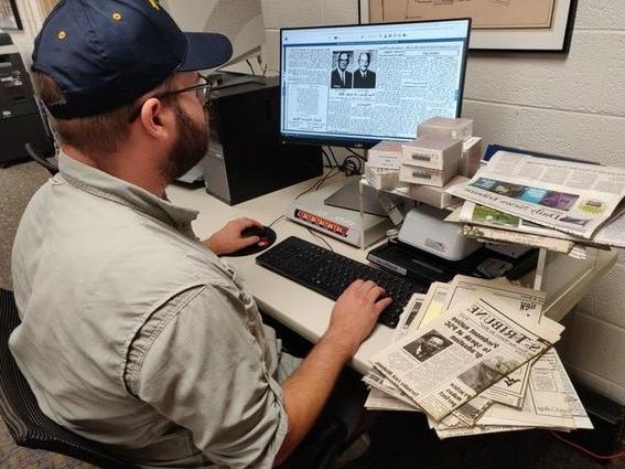 Nick Gardner, interim program coordinator for the WVU Potomac State College library, demonstrates how easily accessible some local newspapers are now that these have been digitized. 